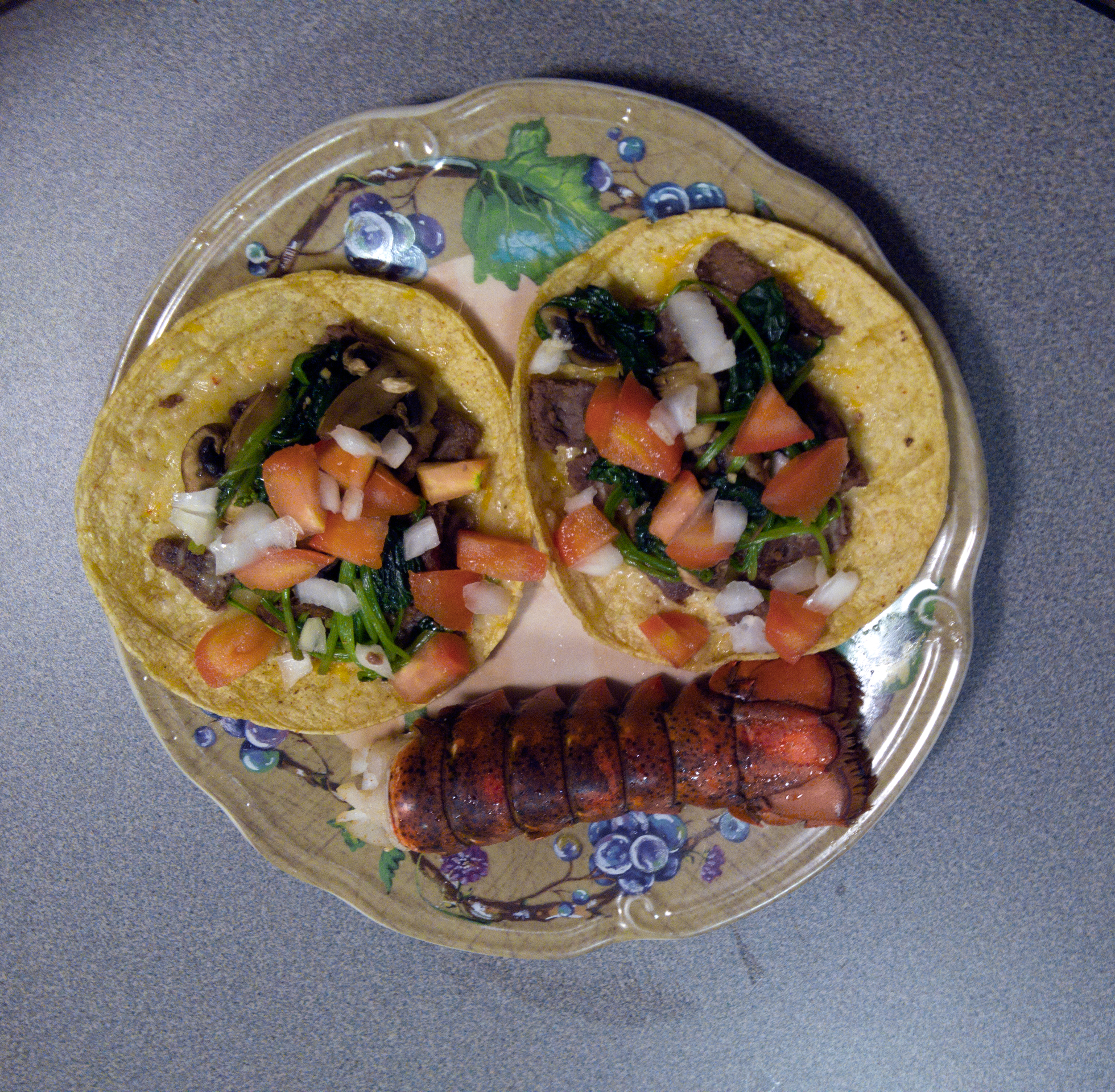 Percy preparing Surf & Turf Tacos with yummy lobster tails